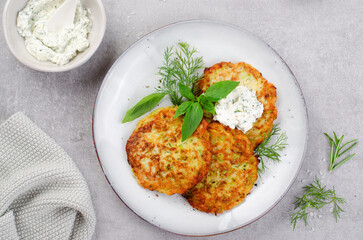 Zucchini Fritters with Herbs and Cream Cheese Topping, Tasty Vegetable Pancakes - obrazy, fototapety, plakaty
