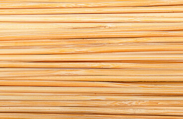 Closeup abstract background of bamboo sticks stacked next to each other