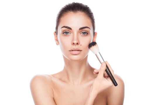 closeup portrait of young adult woman with brush for makeup isolated on white