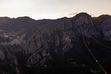 Naklejka premium View of Pietrapertosa and Castelmezzano. Two beautiful villages built on the Lucanian Dolomites in Italy. Connected by a zipline that crosses the valley adrenaline-pumping experience. Day and sunset.