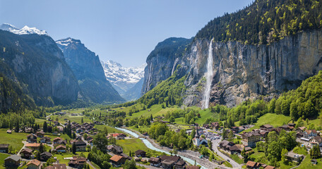Aerial panorama image of the beautiful village Lauterbrunnen with Staubbach waterfall and snow...