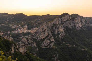 Fototapeta premium View of Pietrapertosa and Castelmezzano. Two beautiful villages built on the Lucanian Dolomites in Italy. Connected by a zipline that crosses the valley adrenaline-pumping experience. Day and sunset.