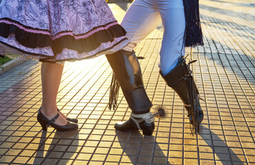 view of the feet of a couple wearing huaso costume dancing the national dance cueca 
