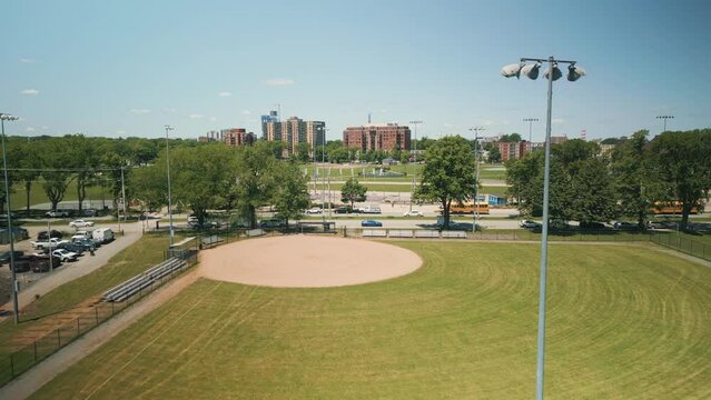 Aerial View of an Empty Baseball Field on a Sunny Day in Downtown Halifax, Canada. Inspirational Sporty Look at Youth Athletics in a Public park. View from the Outfield Near the Massive Lights.