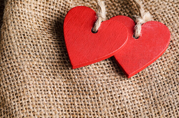 Obraz premium Couple of decorative wooden red hearts for Valentine's day on canvas background