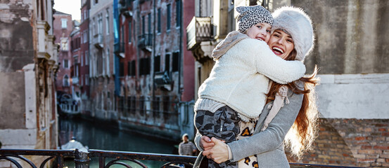 Venice. Off the Beaten Path. smiling trendy mother and daughter tourists in Venice, Italy in the...