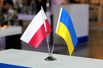 Flags of Poland and Ukraine together at some event or fair. Flags of the two countries as a symbol of cooperation between the two states. Joint business of Ukraine and Poland