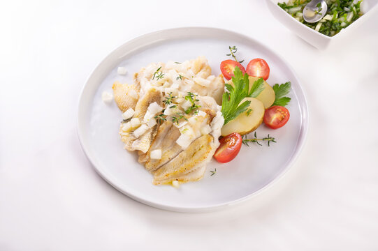 White fish on a plate. Beautifully served fish on a plate with vegetables and spices. High quality photo