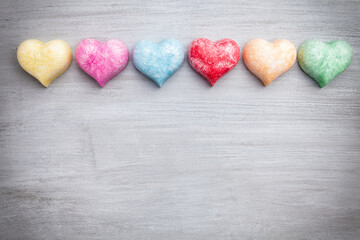 Love concept. Colorful hearts on grey rustic background