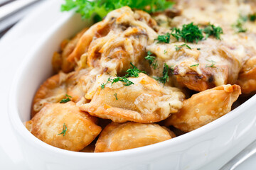 Delicious dumplings with mushroom sauce in a bowl