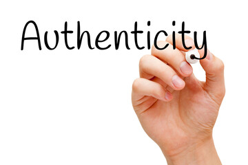 Hand writing Authenticity with black marker on transparent glass board.
