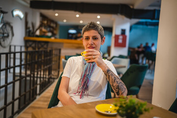 One woman senior caucasian female sit at cafe have a cup of coffee