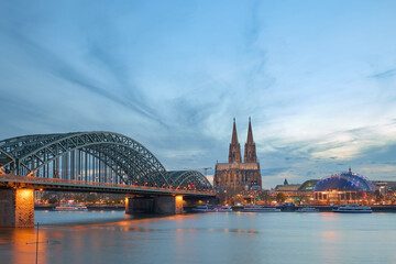 Panoramic view of the Rhine river at sunset as it passes through the city of Cologne in Germany.