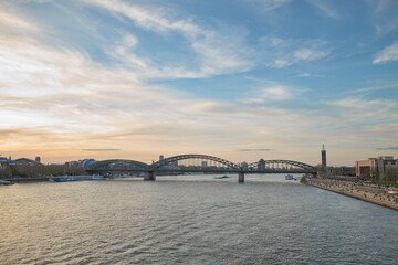Fototapeta na wymiar Panoramic view of the Rhine river at sunset as it passes through the city of Cologne in Germany.