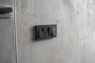 black light switch keys on a gray wall. 