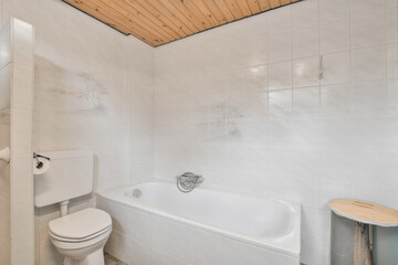 a bathroom with a toilet and bathtub next to the tub that has been installed on the wall in the...