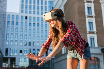 Woman with virtual reality goggles in the city.