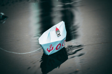 paper boats are standing on the street in a puddle