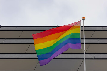 Celebration of pride month in Amsterdam, Rainbow flag hanging outside of the building, The symbol of Gay, Lesbian, Bisexual and Transgender, LGBT community in Holland, Social movements, Netherlands.