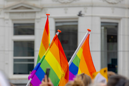 Human rights protest in Amsterdam, People's waving colourful rainbow flag in outdoor public area, The symbol of Gay, Lesbian, Bisexual and Transgender, LGBT community and social movements, Netherlands