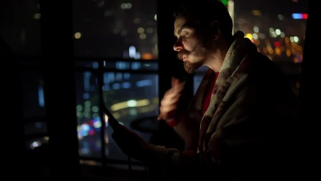Angry caucasian man is shouting at interlocutor by video call holding smartphone in one hand and gesturing by another. Furious young adult male person is arguing communicating with somebody by mobile.