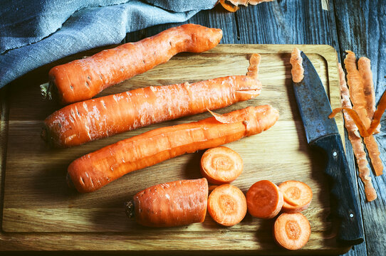 fresh long carrot on a chopping board, top view