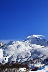 Mount Tetnuldi and off-piste slope with track from ski and snowboard in sun day. Caucasus Mountains, Svaneti region of Georgia.