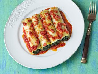 close up of rustic italian vegetarian spinach cannelloni pasta