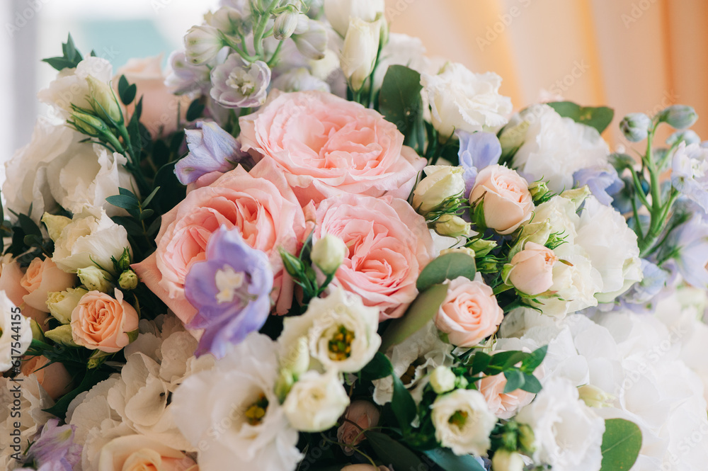 Wall mural wedding decor. beautiful bouquet with white and pink roses and green leaves, closeup