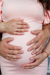 Pregnancy. Future parents. Parents' hands on tummy. Waiting. High quality photo