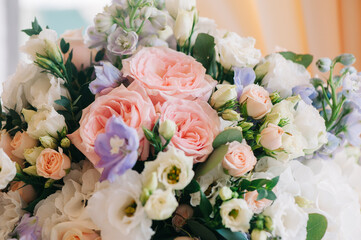 Wedding decor. Beautiful bouquet with white and pink roses and green leaves, closeup