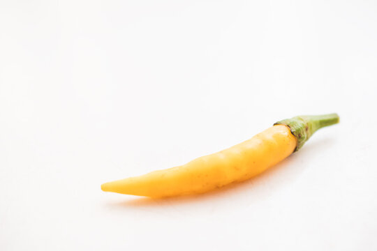 Yellow hot chili peppers on white background © Branimir