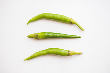Green hot chili peppers on white background