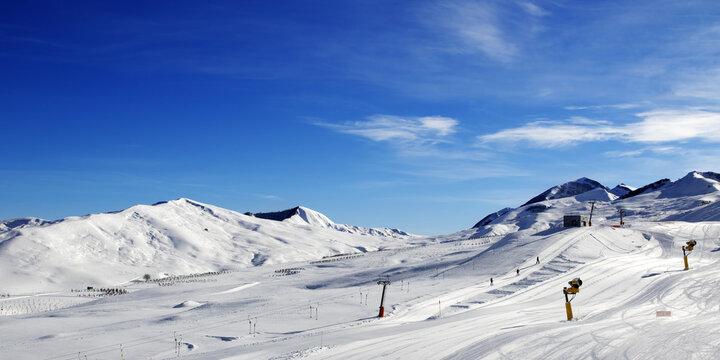 Panoramic view on ski slope with snowmaking at sun day. Greater Caucasus, Mount Shahdagh, Azerbaijan.