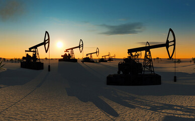 oil pumps in the desert at sunset