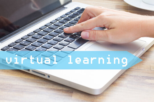Virtual learning concept - hand tounching laptop keyboard