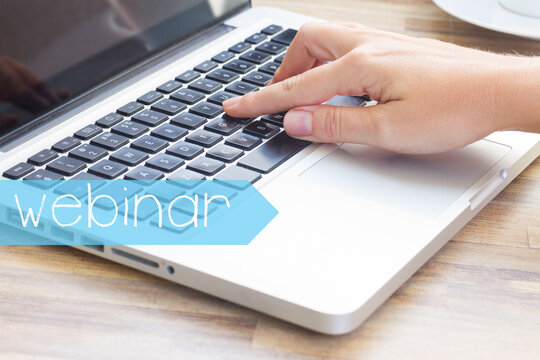 Virtual learning webinar concept - hand tounching laptop keyboard