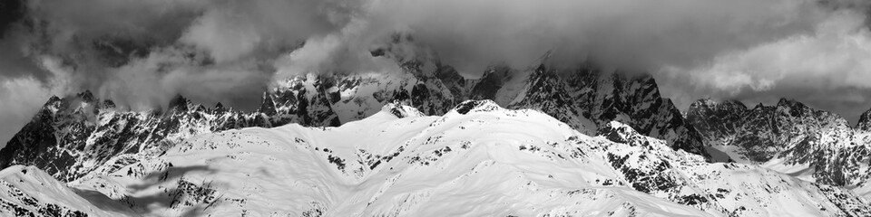 Black and white panoramic view on Mounts Ushba and Chatyn in haze at sunny day. Caucasus Mountains. Svaneti region of Georgia.