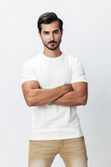 Male fashion model in a white t-shirt and jeans, smile with teeth joy on a white isolated background, trendy clothing style, copy space, space for text