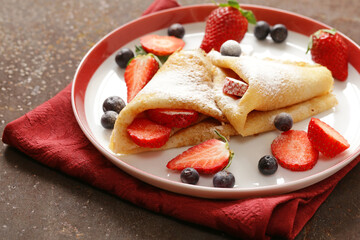 Thin pancakes crepes with berries for dessert