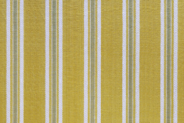 Natural linen texture as background. Cotton fabric with yellow and white line striped pattern, texture close up. Backdrop, wallpaper. Matereal for clothes, curtain and upholstery