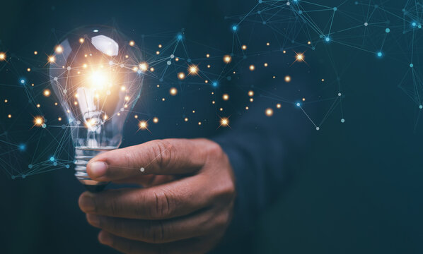 New creativity and innovation are keys to business successful, Thinking and creative concept, Businessman's hand holding creative light bulb with a network technology, Planning for strategy.