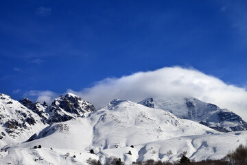 Mountains in clouds and off-piste slope in winter. Caucasus Mountains, Mount Tetnuldi, Svaneti region of Georgia.
