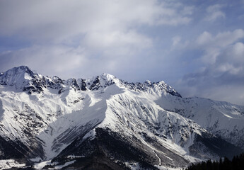 Snow winter mountain and gray sky in evening. Caucasus Mountains. Svaneti region of Georgia.