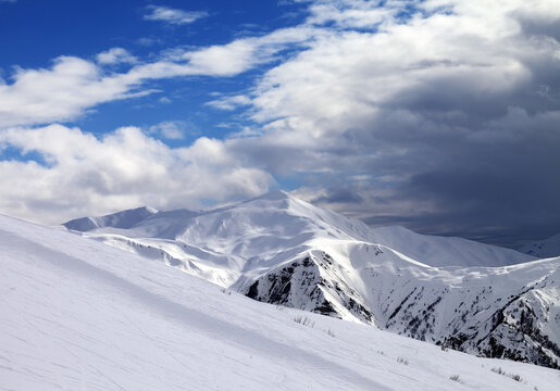 Ski slope in evening and storm clouds. Mount Tetnuldi, Caucasus Mountains, Svaneti region of Georgia.