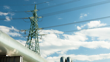 pipeline and power lines against the blue sky