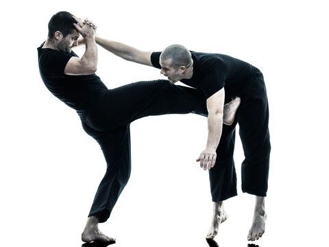 two caucasian men krav maga fighters fighting isolated silhouette on white background