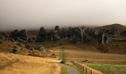 Nature landscape panorama of limestone boulder rocks in dry grass vegetation at Castle Hill in Canterbury New Zealand