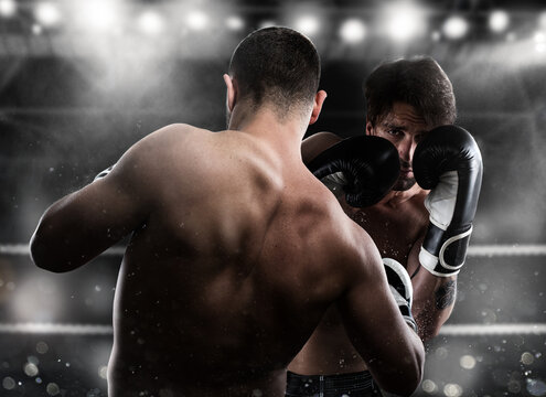Boxer in a boxe competition beats his opponent with a punch