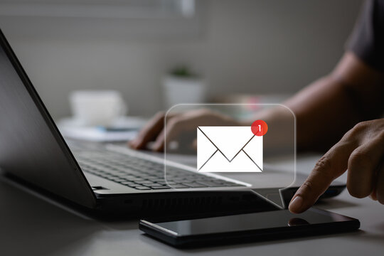 New email notification concept for business e-mail communication and digital marketing. Inbox receiving electronic message alert. Hand of businessman using smartphone for email with notification alert